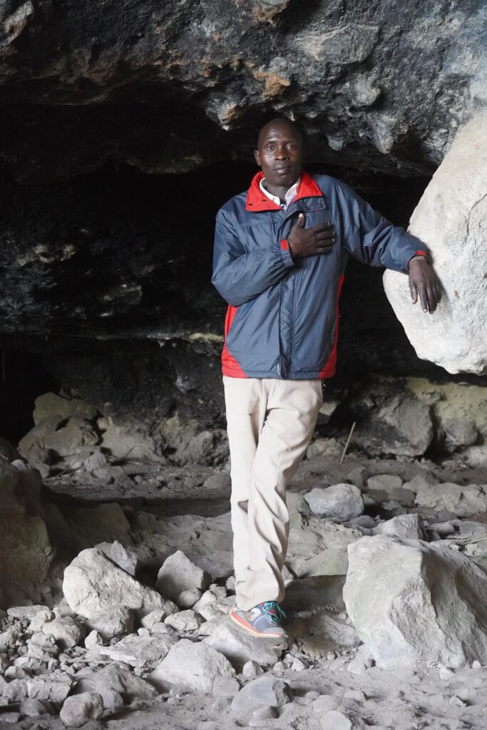 Guy standing in cave