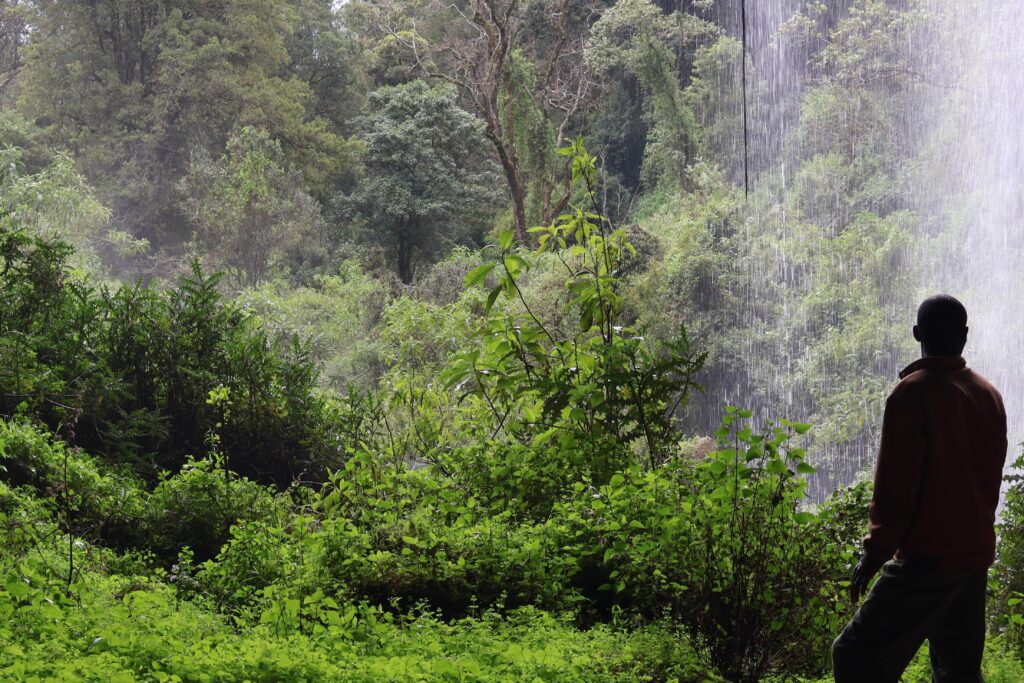 Man at entry of cave